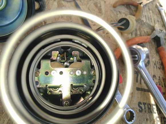 Another angle, the spring seats between the screws and the housing and is a tight fit.