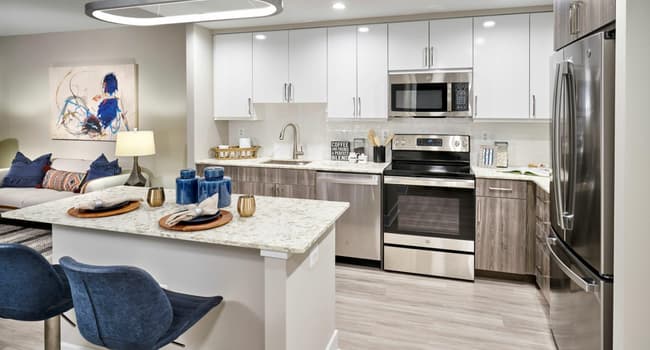 Expansive Kitchens With Quartz Countertops, Two-Tone Cabinetry, Energy Efficient Stainless Steel Appliances, Islands and Wood-Style Flooring